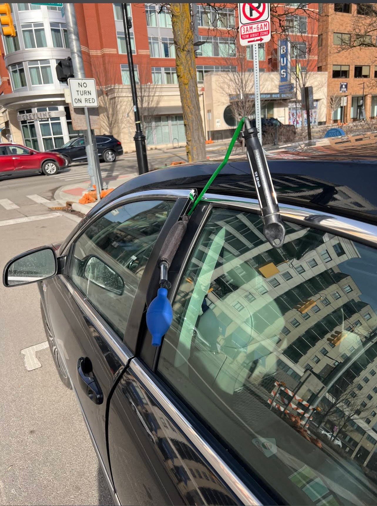 Car lockout service tools at a vehicle door