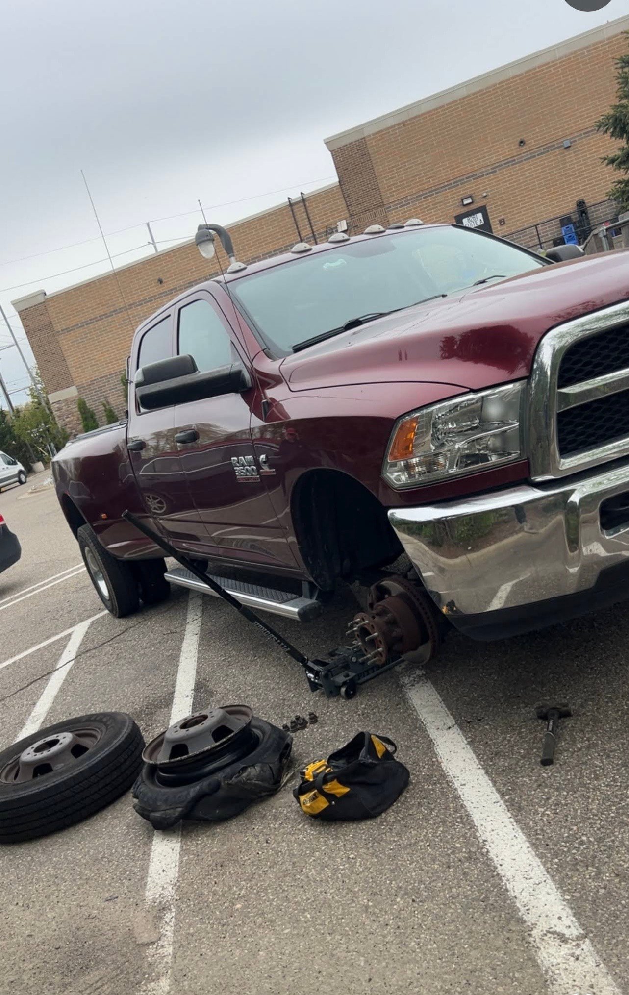 Pickup truck raised on a jack during a flat tire change