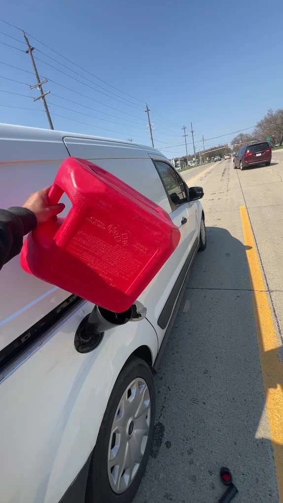 Fuel can beside a vehicle during roadside fuel delivery